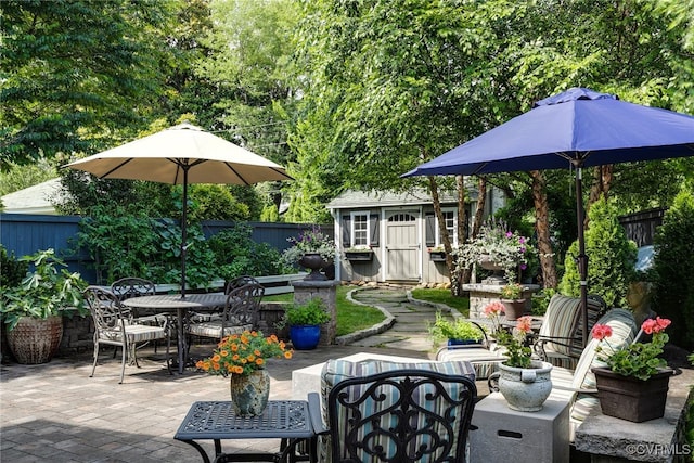 5005 Caledonia Rd, Richmond, VA 23225 - fenced backyard with outdoor dining area, a patio area, and an outbuilding