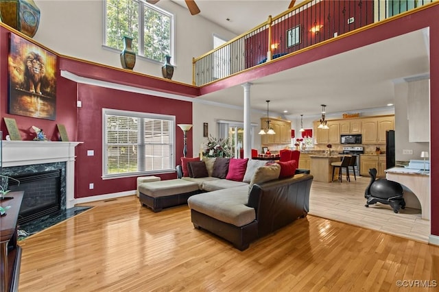 301 Enon Oaks Ln, Chesterfield, VA 23836 - living room featuring a towering ceiling, light wood-style flooring, ceiling fan, a fireplace, and recessed lighting