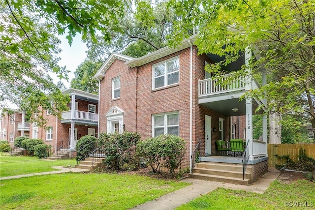 4302 W Franklin St, Richmond, VA 23221 - view of front of home featuring a balcony, brick siding, and a front lawn