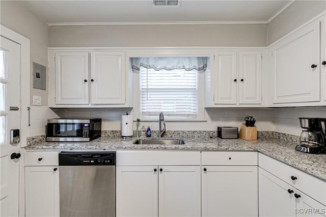 4302 W Franklin St, Richmond, VA 23221 - kitchen with appliances with stainless steel finishes, white cabinetry, decorative backsplash, and crown molding