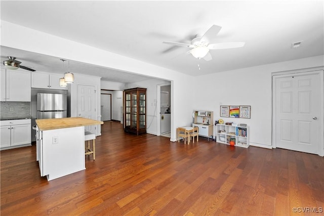 503 S Holly Ave, Henrico, VA 23075 - kitchen featuring ceiling fan, butcher block countertops, a breakfast bar, and white cabinets