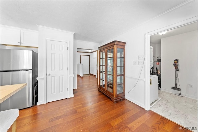 503 S Holly Ave, Henrico, VA 23075 - kitchen with freestanding refrigerator, light countertops, light wood-style flooring, crown molding, and white cabinetry
