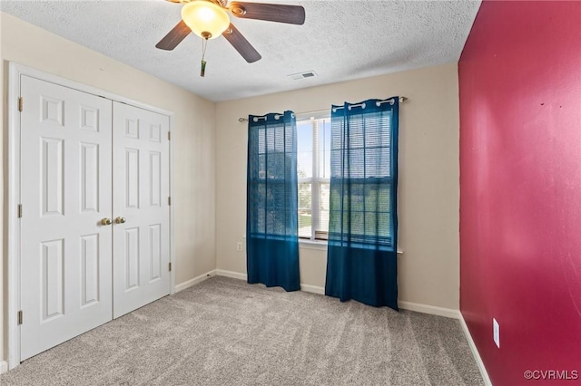 135 Hobbs Hole Ln, Tappahannock, VA 22560 - unfurnished bedroom with a textured ceiling, carpet, ceiling fan, and a closet