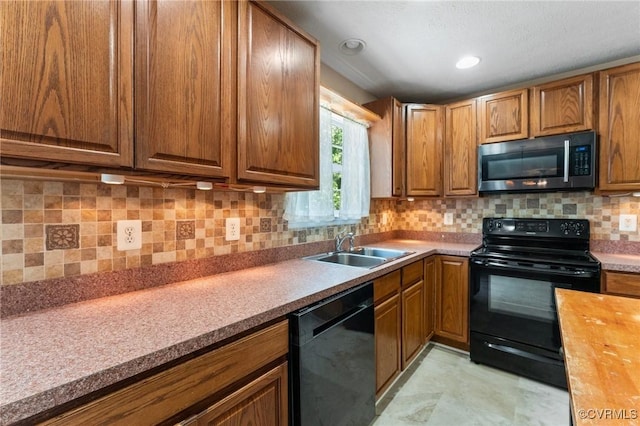135 Hobbs Hole Ln, Tappahannock, VA 22560 - kitchen with black appliances, brown cabinetry, and decorative backsplash