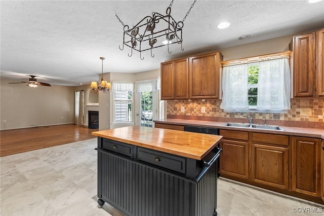 135 Hobbs Hole Ln, Tappahannock, VA 22560 - kitchen featuring wooden counters, a chandelier, a textured ceiling, healthy amount of natural light, and backsplash