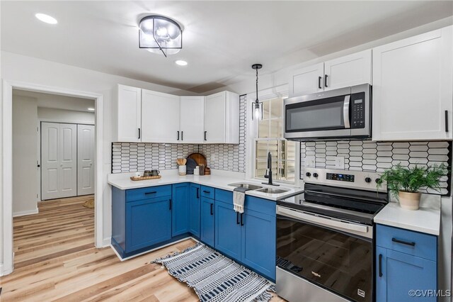 5318 Pine Hill Rd, Sutherland, VA 23885 - kitchen with appliances with stainless steel finishes, light countertops, white cabinetry, blue cabinetry, and recessed lighting