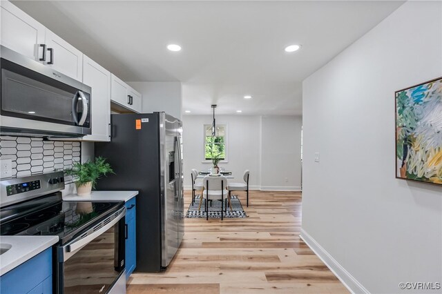 5318 Pine Hill Rd, Sutherland, VA 23885 - kitchen featuring appliances with stainless steel finishes, light wood-style flooring, white cabinets, recessed lighting, and light countertops