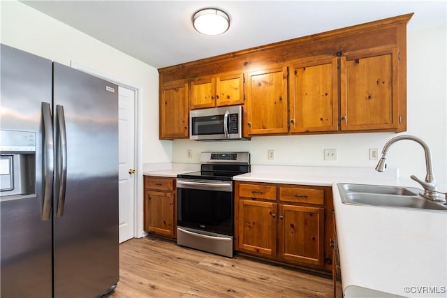 11556 New Forest Trl, Chesterfield, VA 23112 - kitchen with appliances with stainless steel finishes, brown cabinetry, light countertops, and light wood-style floors