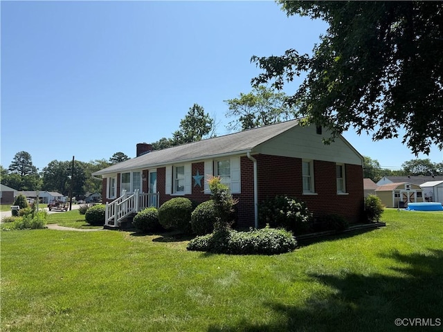 4901 Clayton Rd, Henrico, VA 23231 - view of front of house with a front yard, brick siding, and a chimney