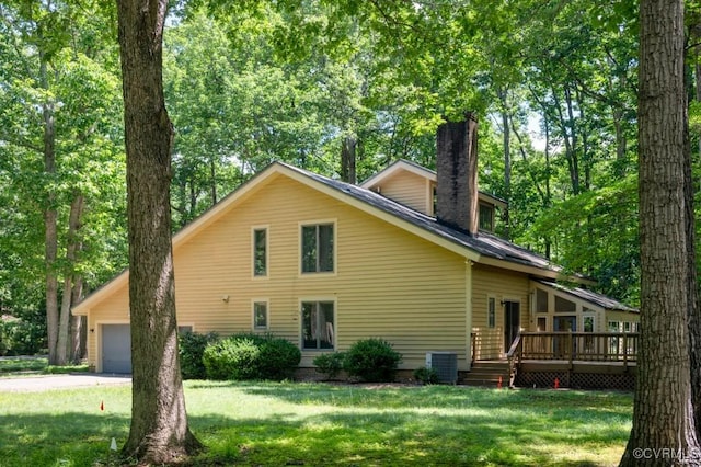 12931 River Hills Dr, Richmond, VA 23111 - rear view of house with a chimney, a wooden deck, a yard, driveway, and an attached garage