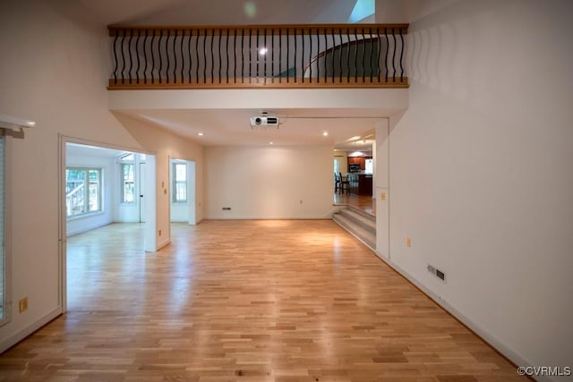 12931 River Hills Dr, Richmond, VA 23111 - unfurnished living room with light wood-type flooring and a high ceiling