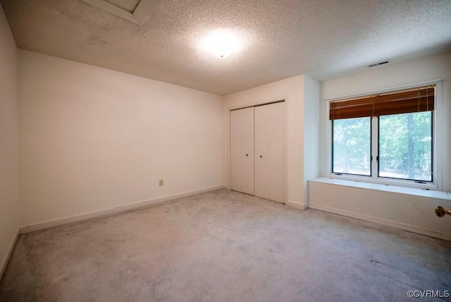 12931 River Hills Dr, Richmond, VA 23111 - unfurnished bedroom with light carpet, a textured ceiling, and a closet