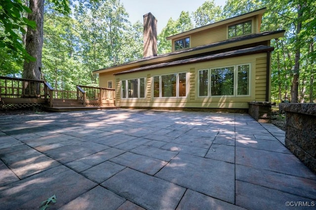 12931 River Hills Dr, Richmond, VA 23111 - back of house with a patio area, a deck, and a chimney