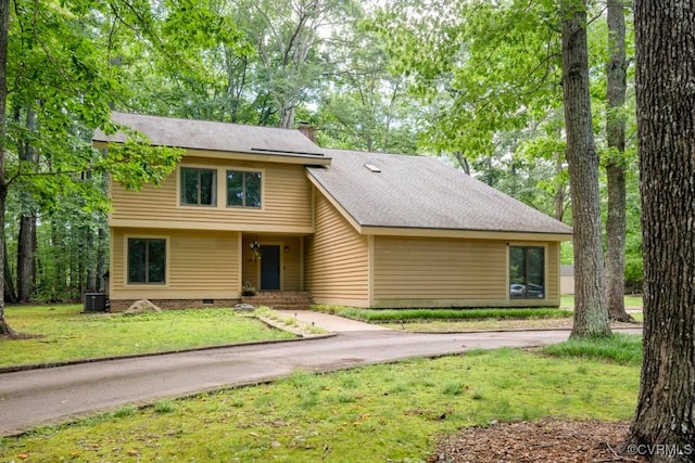 12931 River Hills Dr, Richmond, VA 23111 - view of front facade with a front lawn, a chimney, roof with shingles, crawl space, and driveway