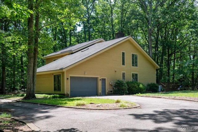 12931 River Hills Dr, Richmond, VA 23111 - view of front of property featuring driveway, a garage, a chimney, and a shingled roof