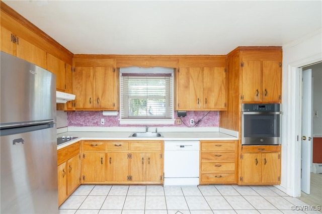 9201 Claymont Dr, Henrico, VA 23229 - kitchen featuring appliances with stainless steel finishes, light countertops, under cabinet range hood, light tile patterned flooring, and decorative backsplash