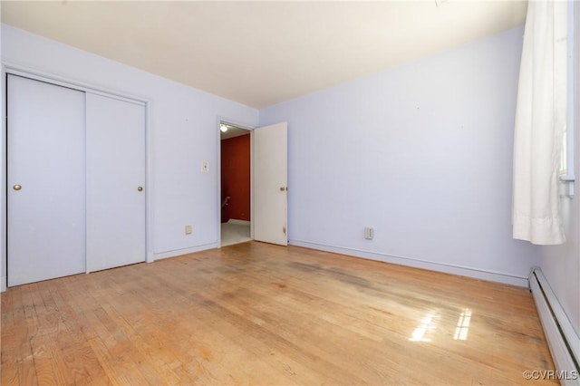 9201 Claymont Dr, Henrico, VA 23229 - unfurnished bedroom featuring a baseboard heating unit, light wood-style floors, and a closet
