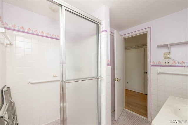 9201 Claymont Dr, Henrico, VA 23229 - full bathroom featuring tile walls, a stall shower, vanity, tile patterned flooring, and wainscoting