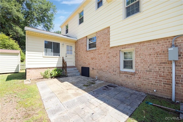 9201 Claymont Dr, Henrico, VA 23229 - rear view of house featuring a patio area, entry steps, a lawn, and brick siding