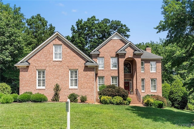 3105 Sapling Dr, Toano, VA 23168 - view of front facade with a front lawn, a chimney, and brick siding