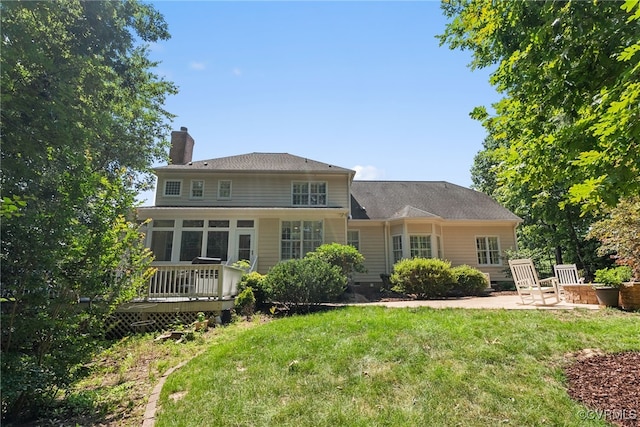 3105 Sapling Dr, Toano, VA 23168 - rear view of house featuring an outdoor fire pit, a chimney, a deck, a yard, and a patio