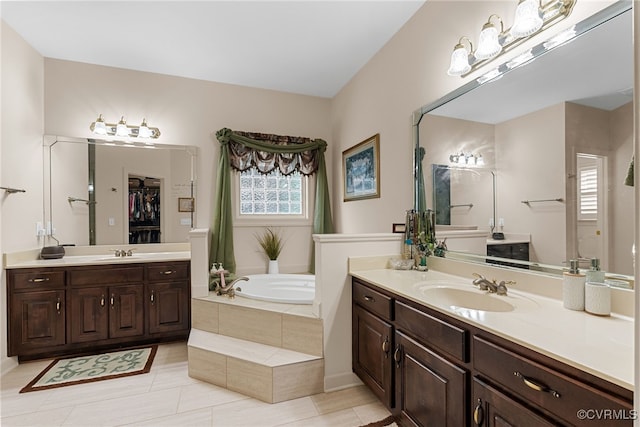 3105 Sapling Dr, Toano, VA 23168 - bathroom with a bath, two vanities, tile patterned floors, and a spacious closet