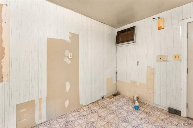 507 Tavern St, Blackstone, VA 23824 - empty room with a wall mounted AC, wood walls, and tile patterned floors