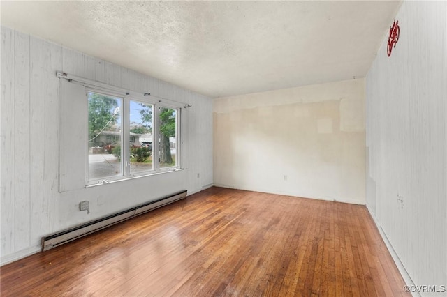 507 Tavern St, Blackstone, VA 23824 - empty room featuring baseboard heating and hardwood / wood-style flooring