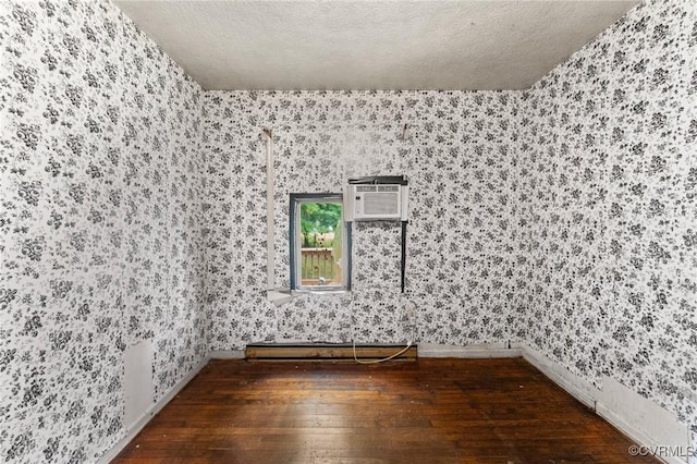 507 Tavern St, Blackstone, VA 23824 - spare room featuring wallpapered walls, wood-type flooring, a wall mounted AC, and a textured ceiling