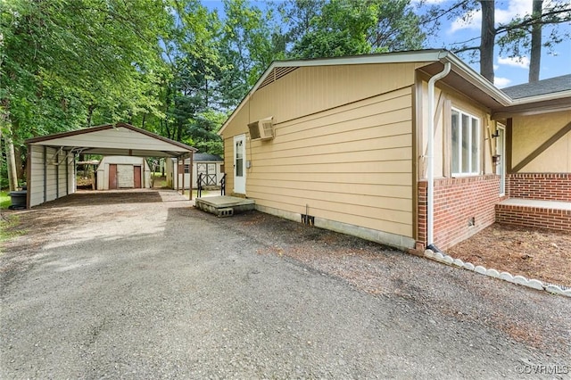 507 Tavern St, Blackstone, VA 23824 - view of home's exterior with a storage unit, a detached carport, crawl space, driveway, and a wall mounted AC