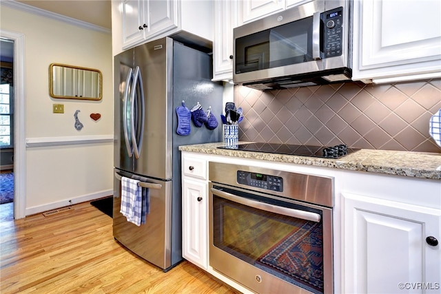 305 E Tazewells Way, Williamsburg, VA 23185 - kitchen featuring appliances with stainless steel finishes, white cabinets, ornamental molding, light wood-style floors, and tasteful backsplash