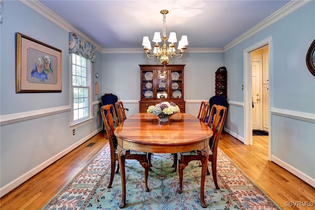 305 E Tazewells Way, Williamsburg, VA 23185 - dining space with light wood-style flooring, a chandelier, and crown molding