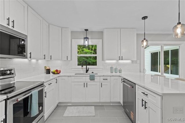 2941 Ellesmere Dr, Midlothian, VA 23113 - kitchen featuring stainless steel appliances, a peninsula, white cabinetry, and tasteful backsplash