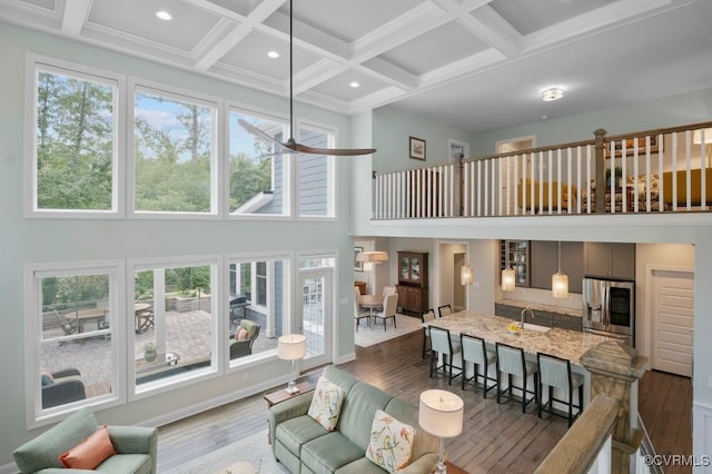 8300 Mckibben Dr, Chesterfield, VA 23838 - living room featuring a towering ceiling, wood finished floors, coffered ceiling, beam ceiling, and recessed lighting