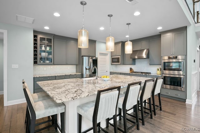 8300 Mckibben Dr, Chesterfield, VA 23838 - kitchen with under cabinet range hood, stainless steel appliances, gray cabinetry, and recessed lighting