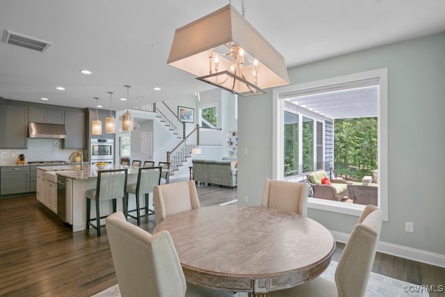 8300 Mckibben Dr, Chesterfield, VA 23838 - dining space with dark wood finished floors, stairway, a chandelier, and recessed lighting
