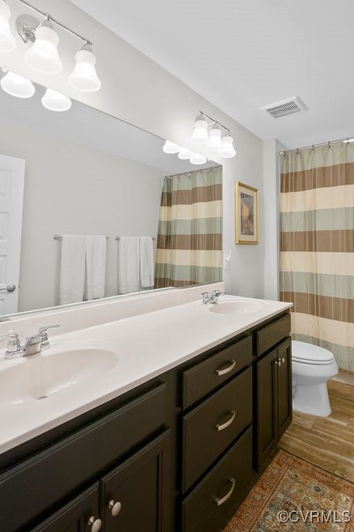 8300 Mckibben Dr, Chesterfield, VA 23838 - bathroom featuring double vanity, wood finished floors, and a shower with shower curtain