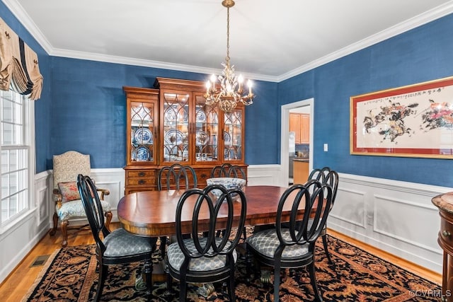 405 Elm Creek Dr, Manakin Sabot, VA 23103 - dining area with a chandelier, wood finished floors, crown molding, and wainscoting