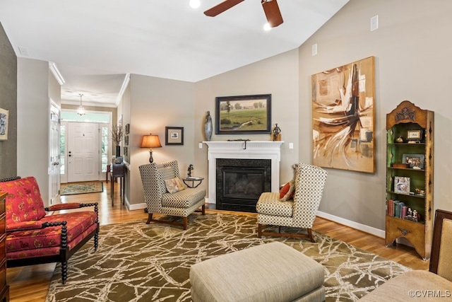 405 Elm Creek Dr, Manakin Sabot, VA 23103 - living area featuring wood finished floors, a ceiling fan, a glass covered fireplace, ornamental molding, and lofted ceiling