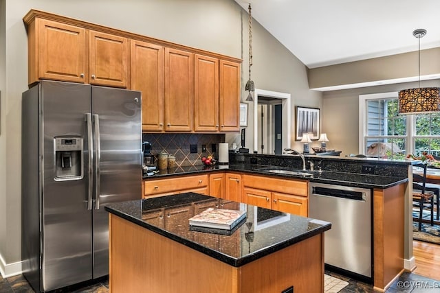 405 Elm Creek Dr, Manakin Sabot, VA 23103 - kitchen with appliances with stainless steel finishes, a peninsula, high vaulted ceiling, decorative backsplash, and brown cabinetry