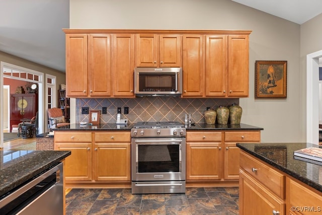405 Elm Creek Dr, Manakin Sabot, VA 23103 - kitchen featuring stainless steel appliances, decorative backsplash, dark stone countertops, dark stone finish floors, and lofted ceiling