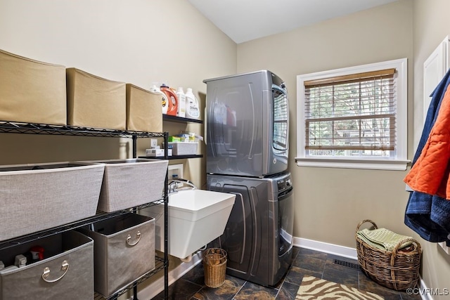405 Elm Creek Dr, Manakin Sabot, VA 23103 - laundry room featuring stacked washer / dryer and stone tile floors
