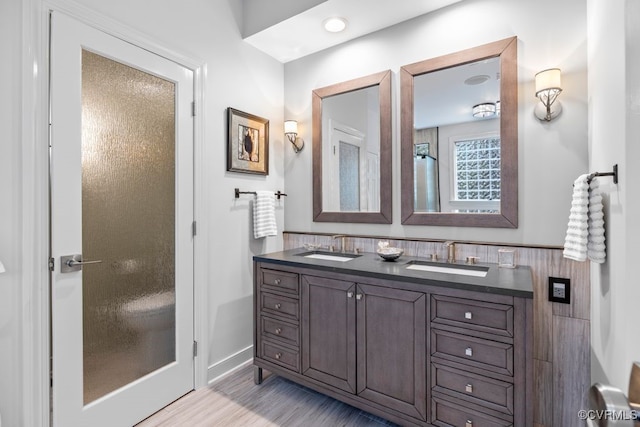 405 Elm Creek Dr, Manakin Sabot, VA 23103 - bathroom featuring double vanity, wood finished floors, and wainscoting