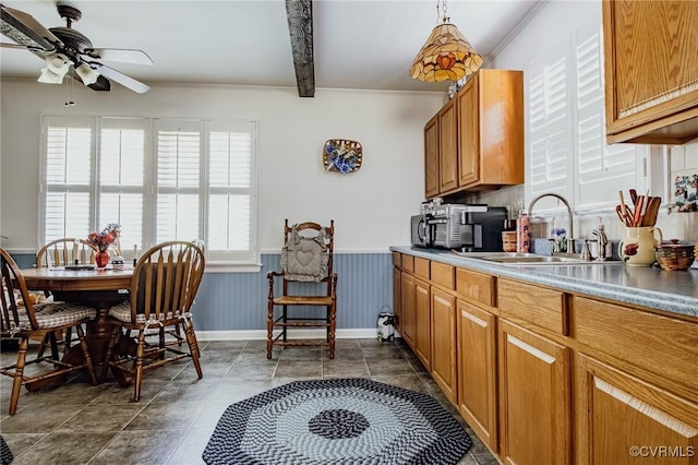 25014 James Ave, Dinwiddie, VA 23803 - kitchen with ornamental molding, a ceiling fan, brown cabinets, and a wainscoted wall