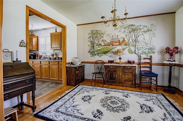 25014 James Ave, Dinwiddie, VA 23803 - dining area featuring a chandelier, light wood finished floors, and crown molding