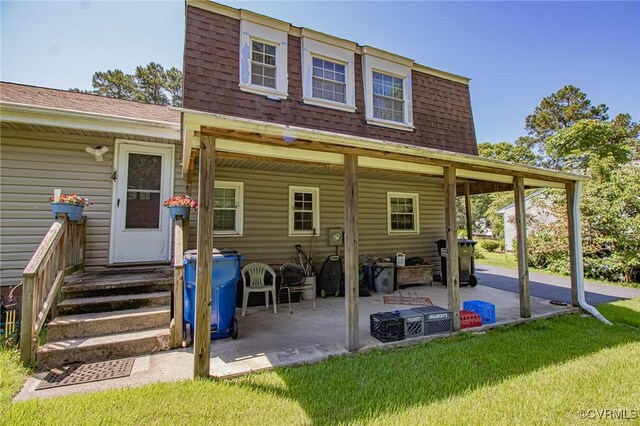 25014 James Ave, Dinwiddie, VA 23803 - rear view of house with a patio area, roof with shingles, and a yard