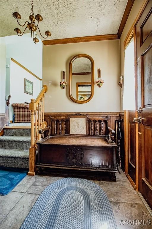 25014 James Ave, Dinwiddie, VA 23803 - bathroom with crown molding, a wainscoted wall, and a textured ceiling