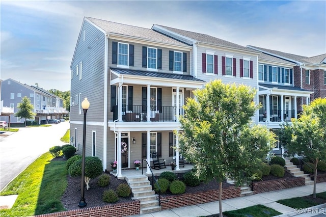 14432 Michaux Village Dr, Midlothian, VA 23113 - view of property with covered porch, stairway, a balcony, a standing seam roof, and a metal roof