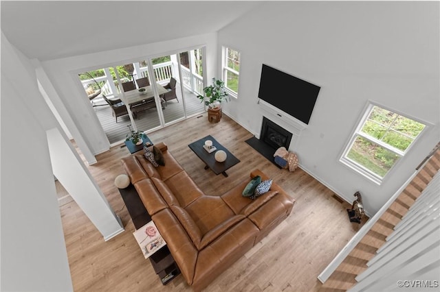 8507 Mckibben Dr, Chesterfield, VA 23838 - living area featuring lofted ceiling, a fireplace with flush hearth, and wood finished floors