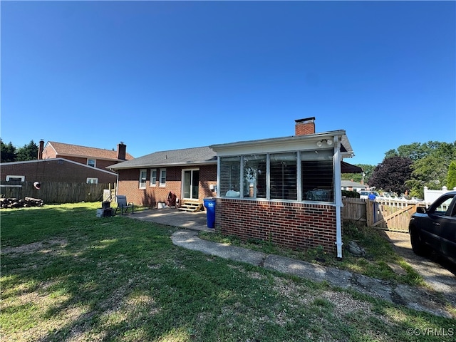 7360 Ford Ave, Mechanicsville, VA 23111 - back of property with entry steps, a chimney, brick siding, and a patio